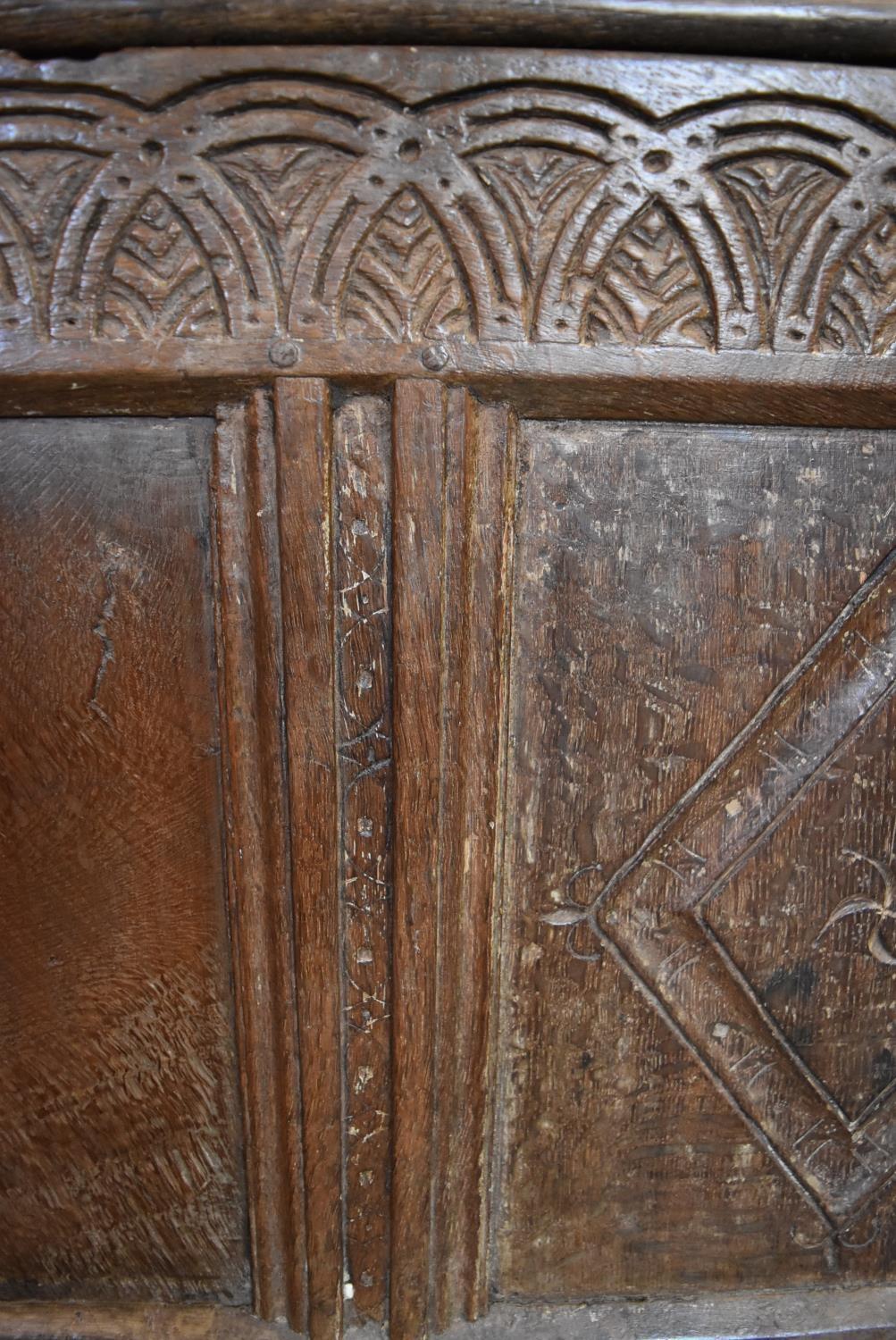 A 17th century carved oak coffer with hinged lidded top and panelled sides with lozenge decoration - Image 3 of 5