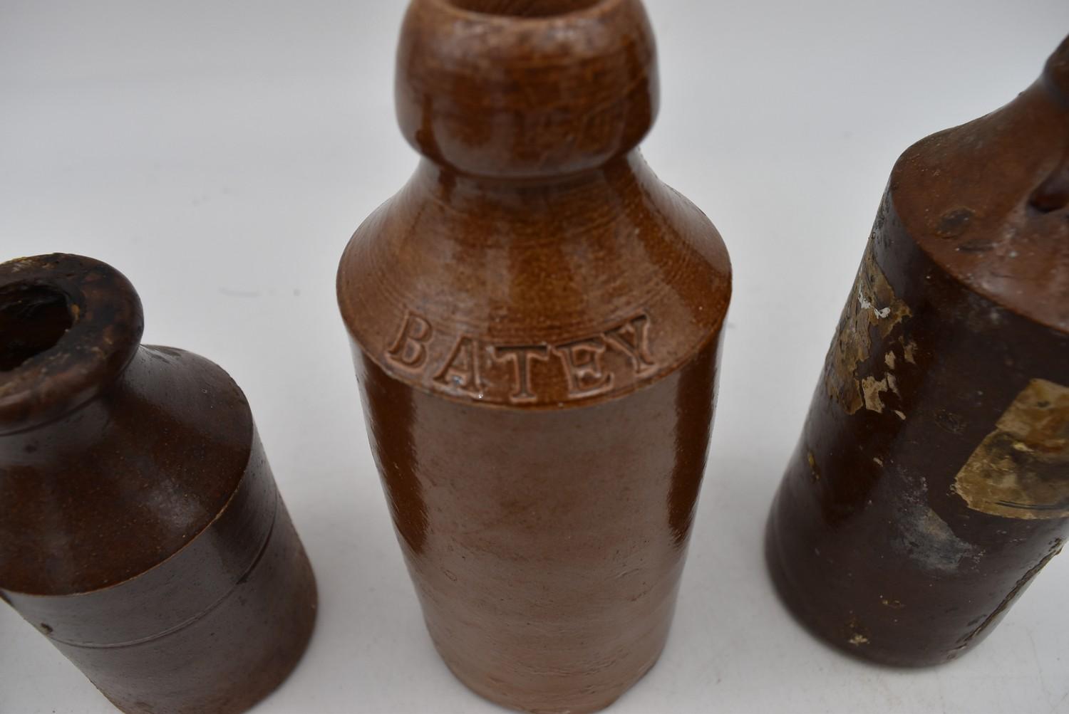 A collection of antique earthenware glazed bottles and jars, some with impressed makers marks. H. - Image 6 of 8