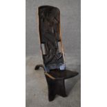 An African carved hardwood two part palaver chair with relief alligator detailing. H.80x20cm