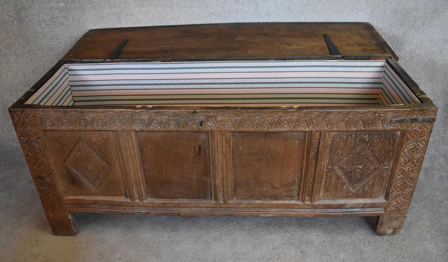 A 17th century carved oak coffer with hinged lidded top and panelled sides with lozenge decoration - Image 4 of 5