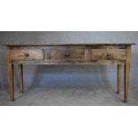 An antique country elm sideboard fitted with three frieze drawers on square tapering supports. H.