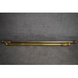 Two brass fluted curtain poles and rings with spherical finials. Longest L.165/Shortest L.138cm