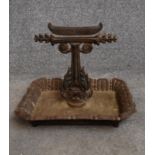 An early 19th century cast iron boot scraper. H.25x32cm