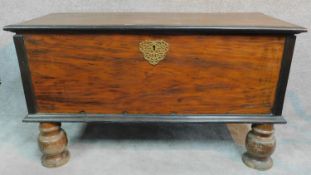 A 19th century Continental ebonised and fruitwood coffer with fret cut brass escutcheon, hinged