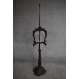 A 19th century adjustable oak fire screen on naturalistically carved base. H.157cm