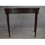 A late Georgian mahogany fold over top tea table on turned tapering supports. H.75x90x45cm (ext.