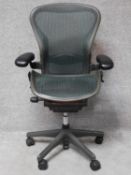 A contemporary Herman Miller Aeron ergonomic design office chair with reclining, swivelling and up