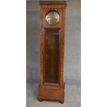 A Continental burr walnut and oak longcase clock with brass dial with weights and pendulum. H.