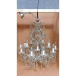 A twelve branch chandelier on a metal frame fitted with crystal swags and drops. H.80 W.75cm