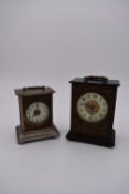 A brass cased carriage clock with engraved brass front with scrolling design and white enamel dial