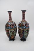 A pair of late 19th century Chinese cloisonné enamel vases with floral decoration and a phoenix