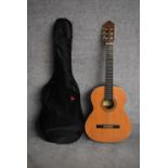 An acoustic guitar by Santos Martinez SM20 Estuduiante Classical, made in Romania, with carrying
