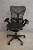 A contemporary Herman Miller Mirra ergonomic design office chair with reclining, swivelling and up