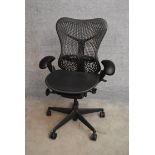 A contemporary Herman Miller Mirra ergonomic design office chair with reclining, swivelling and up