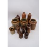 A collection of antique earthenware glazed bottles and jars, some with impressed makers marks. H.