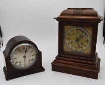 An oak cased bracket clock with brass dial and gilt metal pierced detailing to the corners and