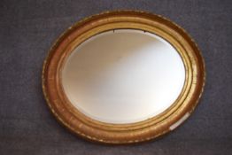 A 19th century gilt framed oval wall mirror. H.80x92cm