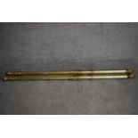 A pair of fluted brass curtain poles and rings with acorn finials. L.170cm