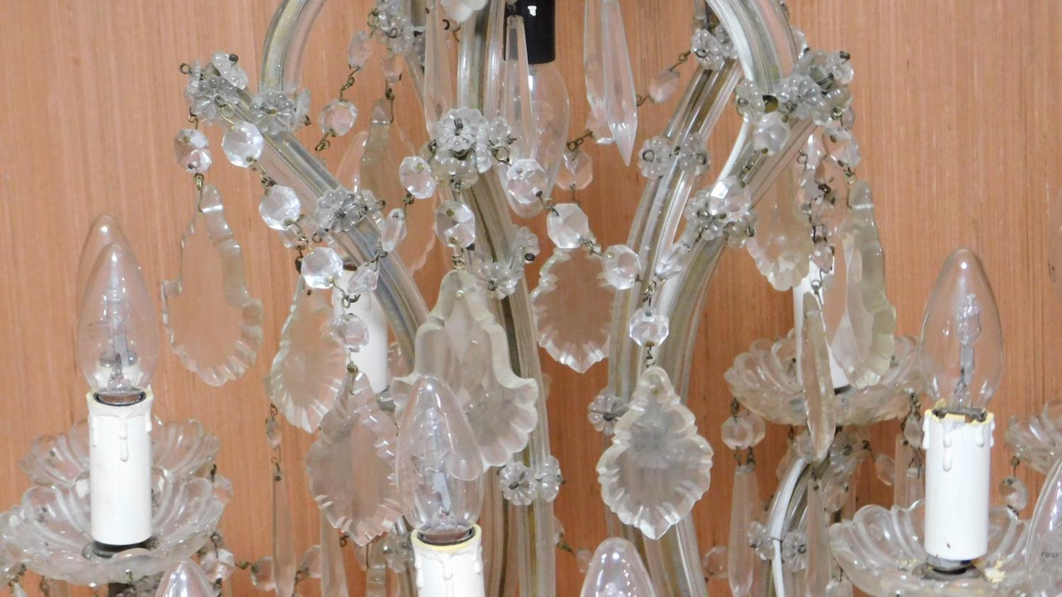 A twelve branch chandelier on a metal frame fitted with crystal swags and drops. H.80 W.75cm - Image 3 of 6