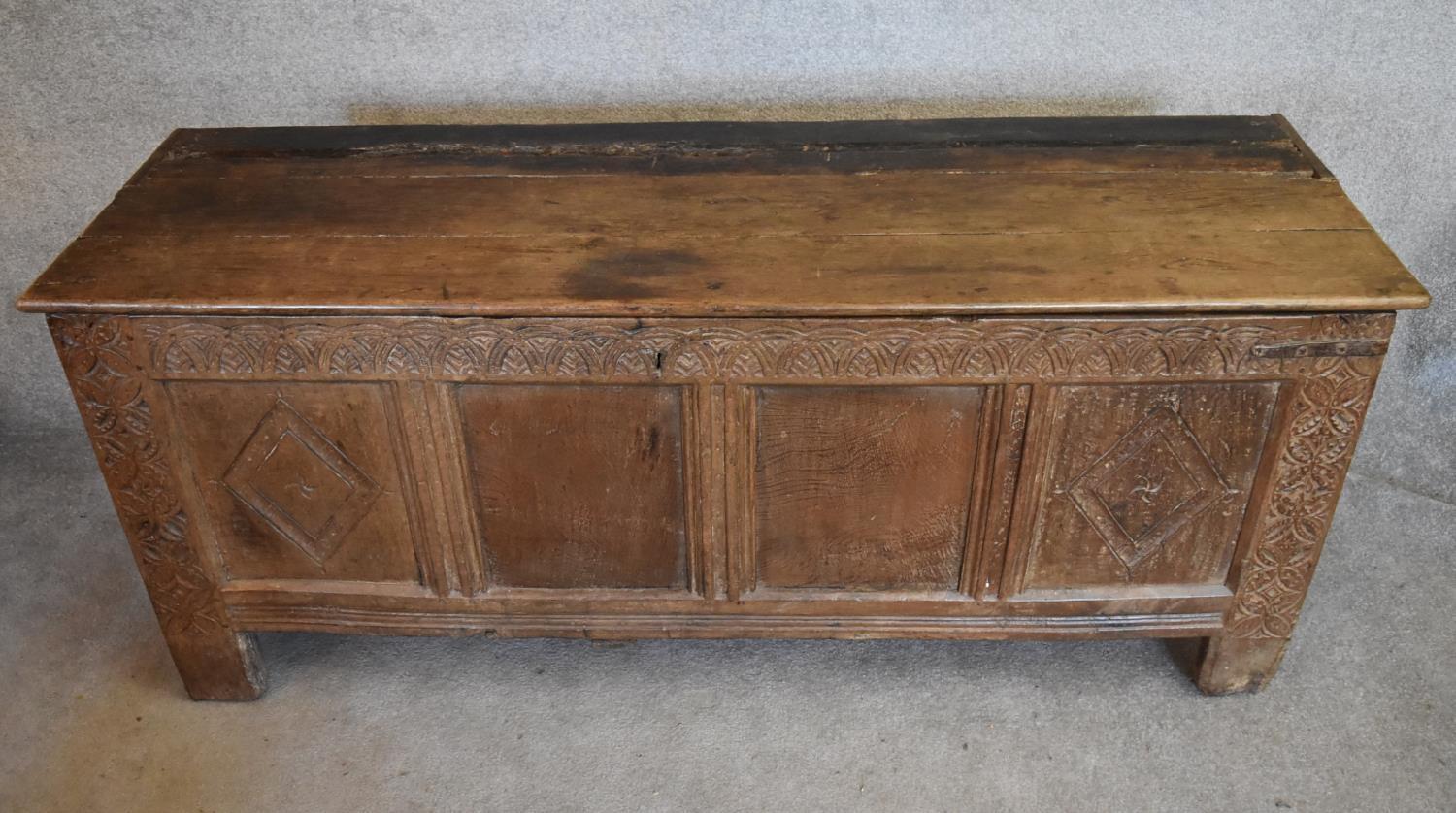 A 17th century carved oak coffer with hinged lidded top and panelled sides with lozenge decoration - Image 2 of 5