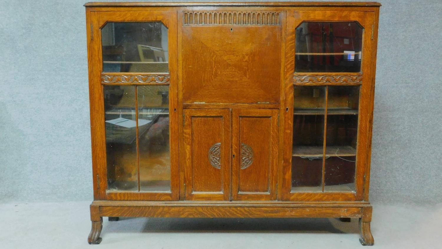 A mid 20th century carved oak bureau bookcase with central fitted secretaire section flanked by - Image 2 of 7