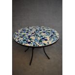 A metal framed conservatory table with mosaic inlaid top. H.72xDia.86cm