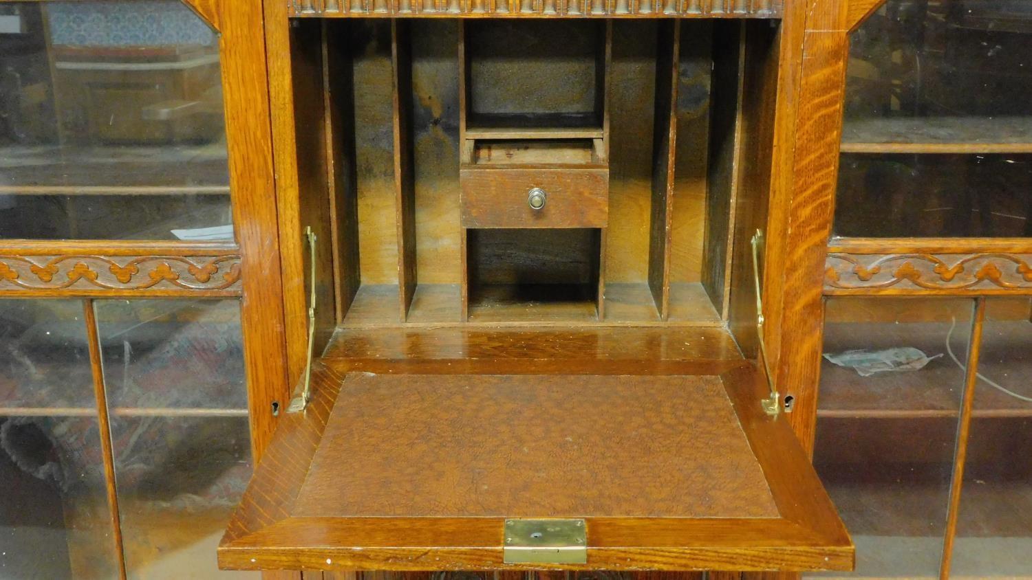 A mid 20th century carved oak bureau bookcase with central fitted secretaire section flanked by - Image 4 of 7