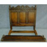 An antique style Ipswich oak standard double bedstead carved with floral motifs. H.144 W.220 D.152cm