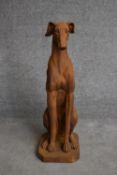 A moulded resin figure of a seated greyhound. H.80cm