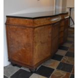 A Continental Art Deco bird's eye walnut and ebonised sideboard fitted with central bank of fitted