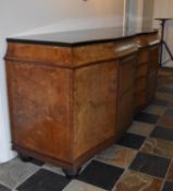 A Continental Art Deco bird's eye walnut and ebonised sideboard fitted with central bank of fitted