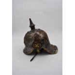 A WW1 style German Prussian lobster tail Pickelhaube helmet. Metal overlapping plates on the