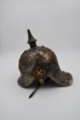 A WW1 style German Prussian lobster tail Pickelhaube helmet. Metal overlapping plates on the