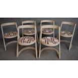 A set of 1970's vintage dining chairs of modernist design with original abstract design seat