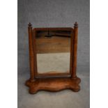 A 19th century burr walnut swing framed toilet mirror on shaped base. H.80x64cm