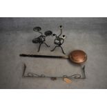 A 19th century copper warming pan, a wrought iron pelmet and two metal candlesticks. L.85cm