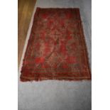 A Tabriz style rug with central pendant medallion on a rouge field with geometric borders, fringed