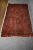 A Tabriz style rug with central pendant medallion on a rouge field with geometric borders, fringed