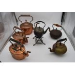 A 19th century silver plated spirit kettle on stand and a collection of five copper and brass