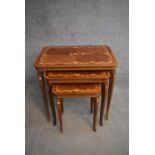 A nest of three graduating Italian kingwood occasional tables with profuse floral inlay on