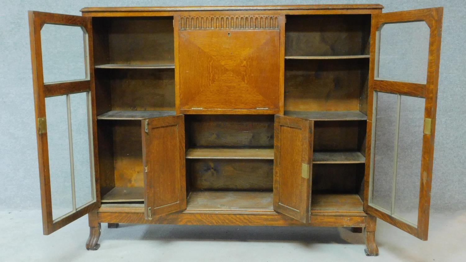 A mid 20th century carved oak bureau bookcase with central fitted secretaire section flanked by - Image 3 of 7