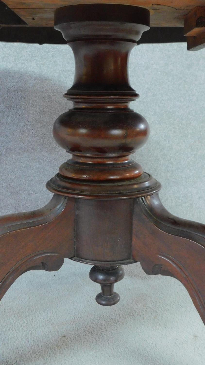 A Victorian mahogany circular dining table with tilt top action raised on carved tripod supports. - Image 4 of 7