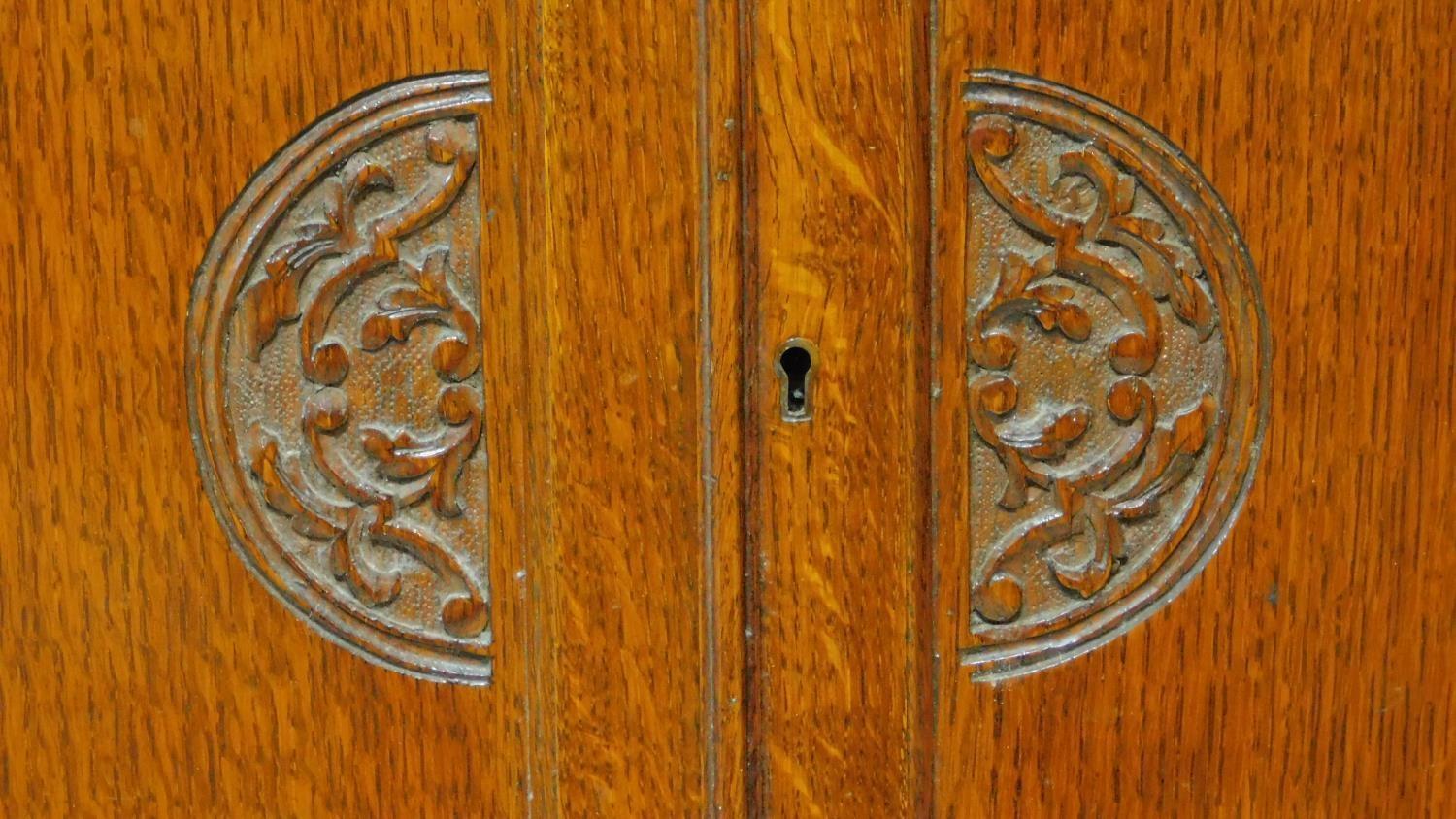 A mid 20th century carved oak bureau bookcase with central fitted secretaire section flanked by - Image 6 of 7