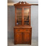 A late Victorian walnut library bookcase with glazed doors above fitted secretaire section and a