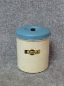 A collection of five vintage painted cream and blue kitchen cannisters and matching large flour tin.