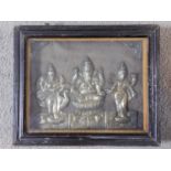 An antique framed and glazed engraved relief picture of Indian deities in white metal. Stamped to