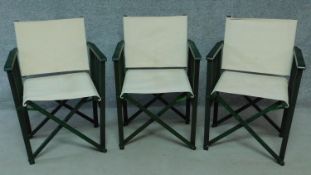 A set of three painted folding director's chairs with canvas seats and back. H.86 W.59 D.50cm
