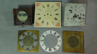 Two antique clock movements together with four antique clock faces. 36x36cm (largest)