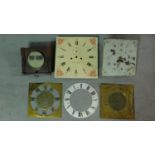 Two antique clock movements together with four antique clock faces. 36x36cm (largest)