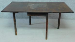 A 19th century mahogany drop leaf dining table on square section supports. H.71 W.150 D.91cm